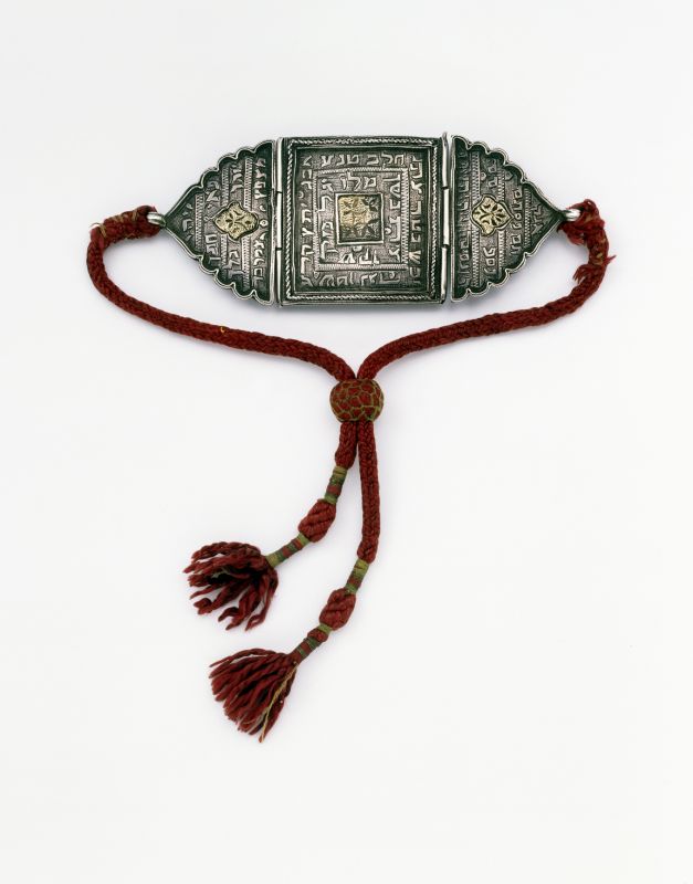 Amulet adorned with magic formula text