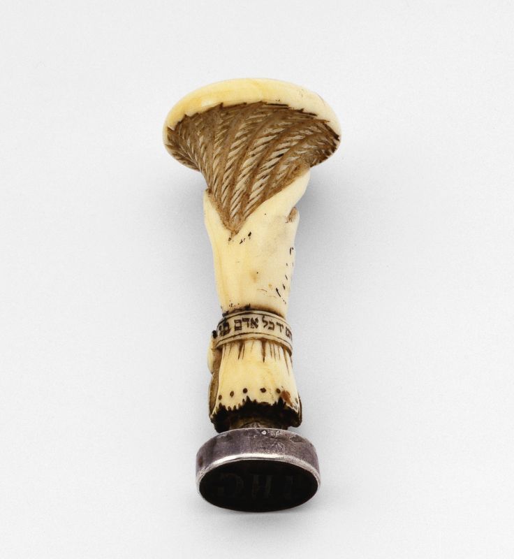 Seal with ivory handle in the form of a hand bearing a torch