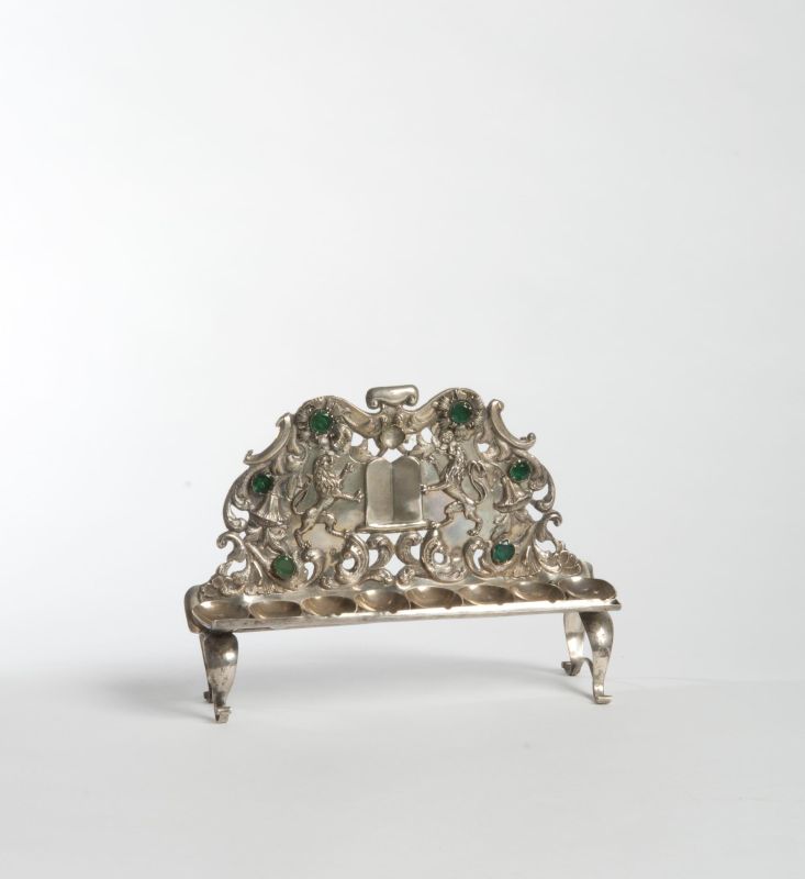 Hanukkah lamp adorned with green stones