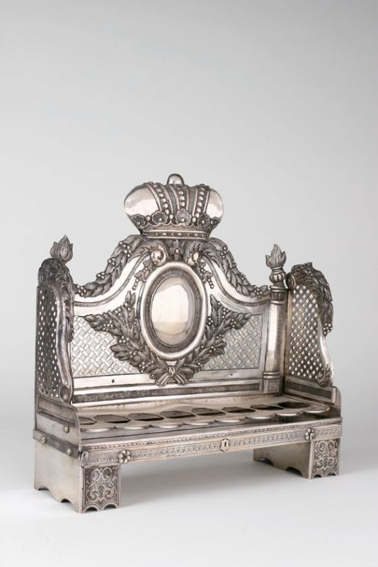 Crowned Hanukkah lamp in the shape of a sofa