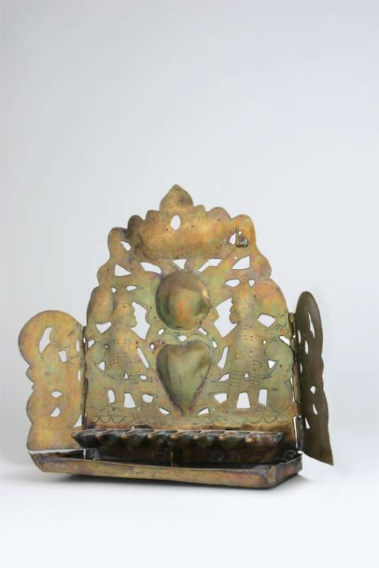 Hanukkah lamp adorned with hearts and two figures