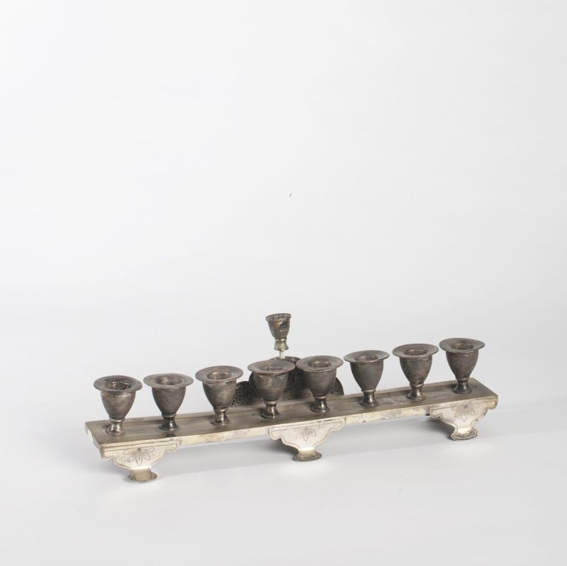 Hanukkah lamp on shaped shelf
