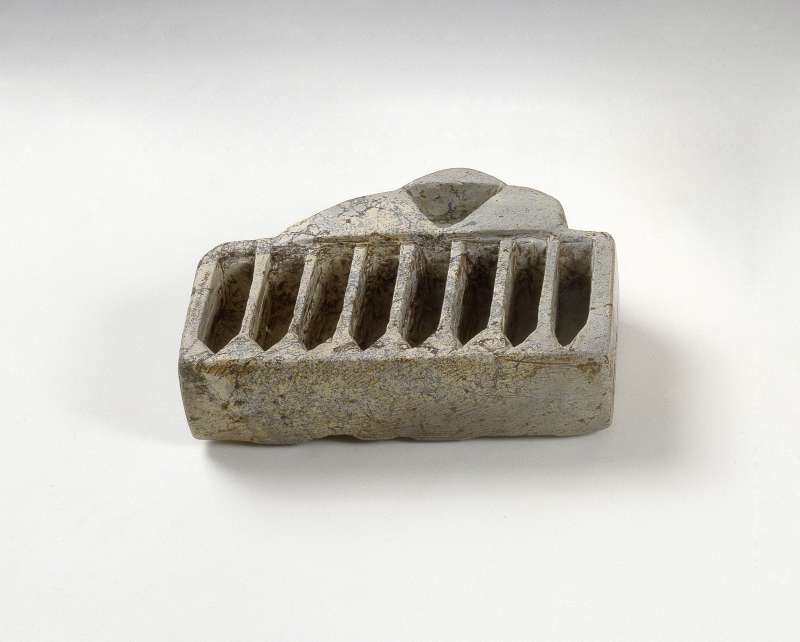 Stone Hanukkah lamp with additional cavity for used wicks