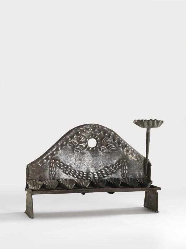 Tin Hanukkah lamp shaped like a bench, with fluted oil fonts