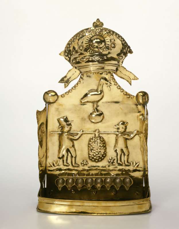 Hanukkah lamp adorned with figures of the Biblical spies in European dress, with city emblem of The Hague, and with hot-air balloons