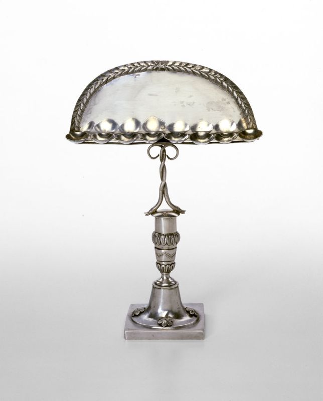 Hanukkah lamp attached to elaborate stem with twisted snakes