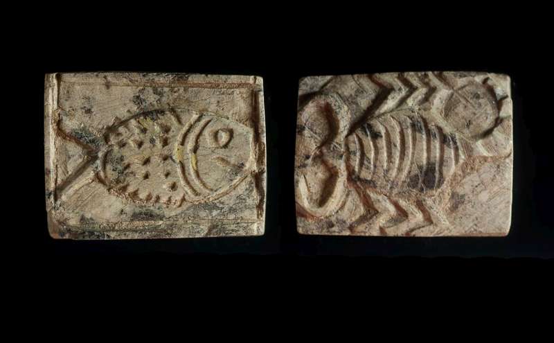 Design amulet depicting a fish on one side, and a scorpion on the other side