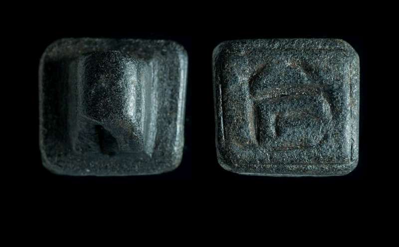 Square design amulet depicting an unclear linear figure