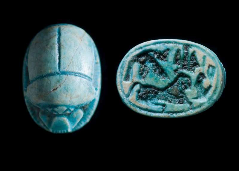 Scarab depicting a reclining sphinx, the goddess Ma'at, and a winged cobra