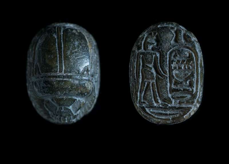 Scarab depicting a male figure facing a meaningless group of hieroglyphs