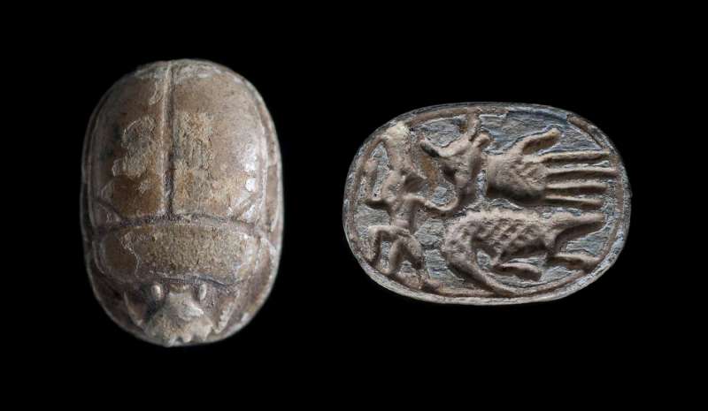 Scarab depicting the god Bes next to a bull's head, a hand, and a crocodile