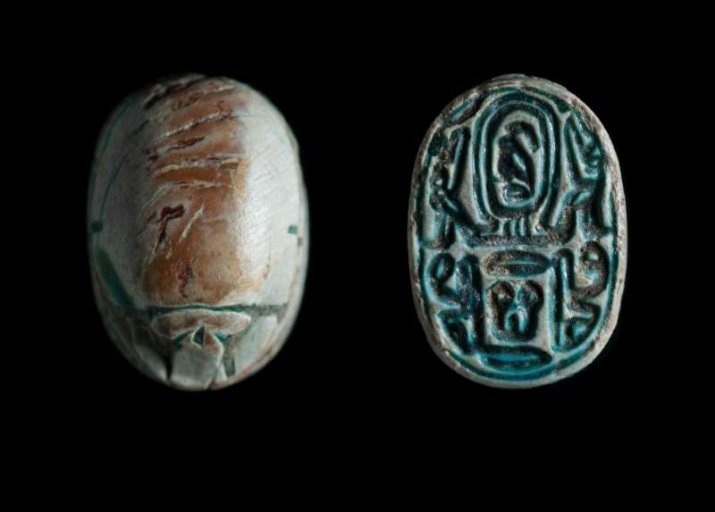 Scarab depicting a symmetric design of hieroglyphs, and a pseudo cartouche flanked by two falcons