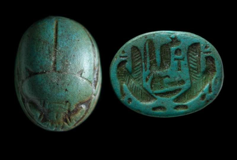 Scarab depicting two falcons flanking a central group of signs: a uraeus, 