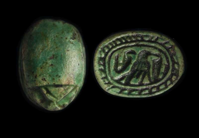 Canaanite scarab depicting a rope border enclosing a falcon flanked by two uraei