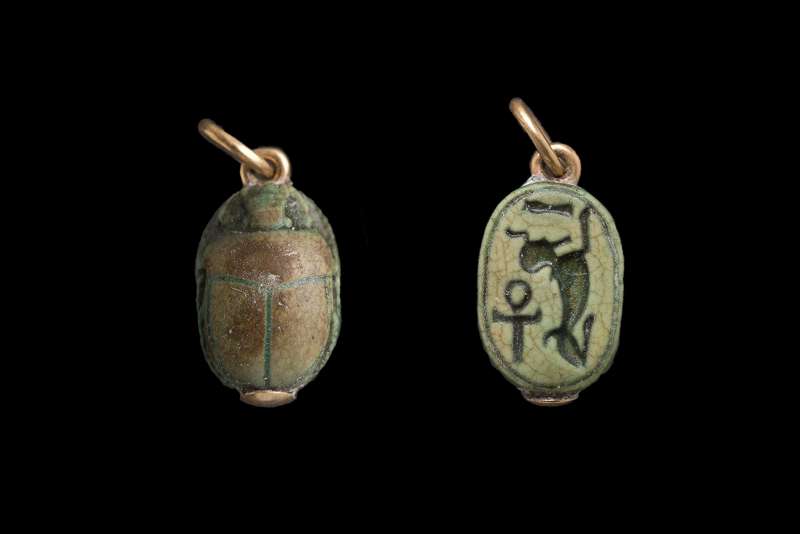 Scarab depicting a reclining sphinx facing a libation vase, with 
