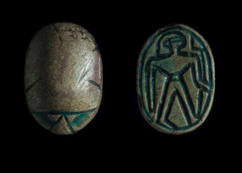Canaanite scarab depicting a male figure holding a flower