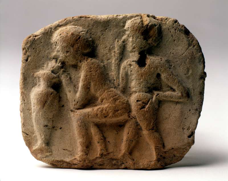 Plaque depicting a copulating couple drinking beer