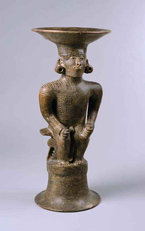 Seated ruler with partially tattooed face and body