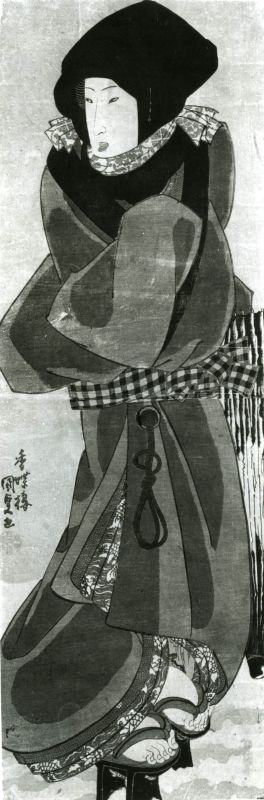 Woman with a closed umbrella in the snow