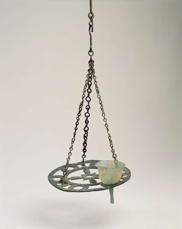 Bronze chandelier with a cross in its center designed to hold seven glass oil lamps