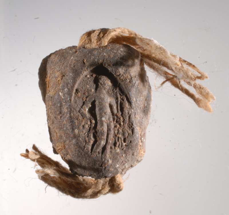 Seal impression (bulla) that sealed an Aramaic papyrus document